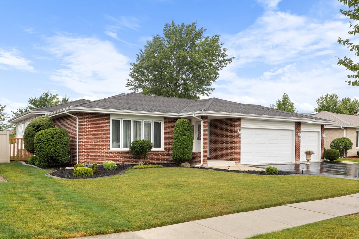 Modern suburban home with brick exterior and lawn